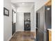 The mud room features dark tile flooring and a new refrigerator and laundry equipment at 2403 N Delaware St, Indianapolis, IN 46205