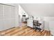 Bright office with hardwood floors, sewing machine, and a rolling chair at 2403 N Delaware St, Indianapolis, IN 46205