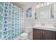 Bathroom with a modern vanity, patterned shower curtain, and stylish white subway tile at 2405 N Park Ave, Indianapolis, IN 46205