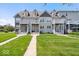 Charming townhome with a well-manicured lawn and inviting front porch, perfect for enjoying the outdoors at 2405 N Park Ave, Indianapolis, IN 46205