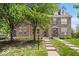 Brick townhome featuring meticulous landscaping, sidewalks and inviting front entrances at 2405 N Park Ave, Indianapolis, IN 46205