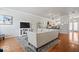 Open living room featuring hardwood floors, media center, an adjoining kitchen and natural light at 2405 N Park Ave, Indianapolis, IN 46205