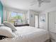 Bright bedroom with a large window, ceiling fan, and ample natural light at 2405 N Park Ave, Indianapolis, IN 46205