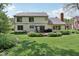 Expansive backyard featuring a patio with dining set, lush lawn and verdant landscaping at 2884 Brook Vista Dr, Carmel, IN 46032