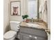 Cozy bathroom featuring a granite countertop, gray vanity, and charming decor at 2884 Brook Vista Dr, Carmel, IN 46032