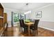 Cozy dining room with wood floors, a large window offering natural light, and modern furnishings at 2884 Brook Vista Dr, Carmel, IN 46032