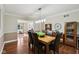 Elegant dining room with wood floors, modern chandelier, and seamless connection to the living area at 2884 Brook Vista Dr, Carmel, IN 46032