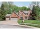 Elegant two story red brick home with a three car garage and a well maintained lawn and landscaping at 2884 Brook Vista Dr, Carmel, IN 46032