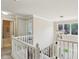 Bright upstairs hallway with white banister and contemporary light fixture at 2884 Brook Vista Dr, Carmel, IN 46032