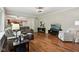 Open-concept living room with hardwood floors, comfortable seating, and a view of the kitchen at 2884 Brook Vista Dr, Carmel, IN 46032