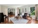 Inviting living room featuring hardwood floors, a plush sofa, and an open dining area at 2884 Brook Vista Dr, Carmel, IN 46032