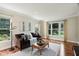 Bright and airy living room with hardwood floors, stylish decor, and plenty of natural light from large windows at 2884 Brook Vista Dr, Carmel, IN 46032