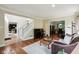 Inviting living room featuring hardwood floors and an open layout that connects seamlessly to other rooms at 2884 Brook Vista Dr, Carmel, IN 46032