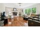 Cozy living room with hardwood floors, a brick fireplace, and large windows overlooking the backyard at 2884 Brook Vista Dr, Carmel, IN 46032