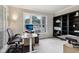 Well-lit home office with large windows, neutral carpet, and a spacious work area at 2884 Brook Vista Dr, Carmel, IN 46032