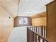 An attic space features wood-paneled walls, textured ceilings, and carpeting with a window at 2908 Fairview St, Anderson, IN 46016