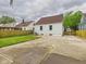 Exterior of house with white siding, visible central air, and grass leading to a wooden fence at 2908 Fairview St, Anderson, IN 46016