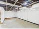 Unfinished basement featuring concrete floor, white walls, and open ceiling with visible ductwork and lighting at 2908 Fairview St, Anderson, IN 46016