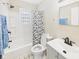 Bright bathroom featuring a shower-tub combo with a shower curtain, toilet, and sink with vanity at 2908 Fairview St, Anderson, IN 46016