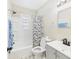 Bright bathroom featuring a shower-tub combo with a shower curtain, toilet, and sink with vanity at 2908 Fairview St, Anderson, IN 46016
