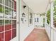 Charming front porch with a red-trimmed door, white railing, and ample space for relaxing outdoors at 2908 Fairview St, Anderson, IN 46016