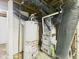 Water heater and furnace with visible ductwork and plumbing in the basement at 2908 Fairview St, Anderson, IN 46016