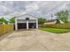 Detached garage with two open doors with a large driveway at 2908 Fairview St, Anderson, IN 46016