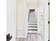 Inviting hallway with gray floors leads to carpeted room and staircase with white risers and black treads at 2908 Fairview St, Anderson, IN 46016
