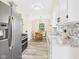Modern kitchen with stainless steel appliances, white cabinets, and an adjacent dining area for easy meals at 2908 Fairview St, Anderson, IN 46016