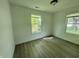 Cozy bedroom with laminate flooring, neutral walls, and two windows for natural light at 3114 Adams St, Indianapolis, IN 46218