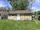 Modest single-story home featuring a brown roof, boarded up windows and a simple front door at 3114 Adams St, Indianapolis, IN 46218