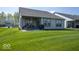 Spacious backyard with a covered patio, lush green lawn, and well-maintained landscaping at 345 Ehrlich Ln, Westfield, IN 46074