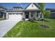 Inviting home with a pristine lawn, attached garage, and covered front porch at 345 Ehrlich Ln, Westfield, IN 46074