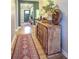 Inviting hallway with wood floors, a rustic cabinet, and a decorative rug at 345 Ehrlich Ln, Westfield, IN 46074