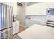 Modern kitchen with stainless steel refrigerator, white subway tile backsplash, white cabinets, and a quartz countertop at 345 Ehrlich Ln, Westfield, IN 46074