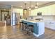 Stylish kitchen featuring a large island with seating, stainless steel appliances, white cabinets, and modern pendant lights at 345 Ehrlich Ln, Westfield, IN 46074