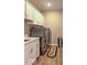 Well-organized laundry room with white cabinets, countertop, stainless steel washer and dryer, and a 'Laundry Room' rug at 345 Ehrlich Ln, Westfield, IN 46074