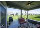 Covered patio featuring outdoor seating, a grill, and a view of the well-maintained backyard at 345 Ehrlich Ln, Westfield, IN 46074