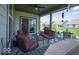 Cozy covered patio with ample seating, perfect for entertaining, and a view of the green backyard at 345 Ehrlich Ln, Westfield, IN 46074