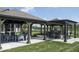 Shaded outdoor area with multiple pergolas, cozy seating, and a built-in grill for community gatherings and events at 345 Ehrlich Ln, Westfield, IN 46074
