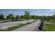 Community entrance with landscaped median, street, and sidewalk at 345 Ehrlich Ln, Westfield, IN 46074