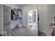 Organized walk-in closet featuring shelves, storage accessories, and hanging racks that leads to an en suite bathroom at 345 Ehrlich Ln, Westfield, IN 46074