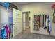 Large walk-in closet with installed hanging racks, shelves, shoe racks, storage space, and a doorway to a bathroom at 345 Ehrlich Ln, Westfield, IN 46074