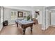 Finished basement featuring a pool table, neutral walls, wood-look flooring, and walkout access at 3546 Brampton Ln, Westfield, IN 46074