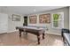 Spacious basement with a pool table, neutral walls, wood flooring, and natural light from window at 3546 Brampton Ln, Westfield, IN 46074