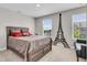 Cozy bedroom with a wood frame bed, neutral carpet, and natural light from the windows at 3546 Brampton Ln, Westfield, IN 46074