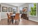 Bright dining room boasts wood floors, a modern table, and natural light streaming through the windows at 3546 Brampton Ln, Westfield, IN 46074