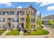 Attractive brick townhome with black shutters, tidy landscaping and inviting curb appeal under a bright blue sky at 3546 Brampton Ln, Westfield, IN 46074