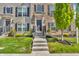 Close-up of the townhome's front door with concrete steps, brick facade, and manicured landscaping at 3546 Brampton Ln, Westfield, IN 46074