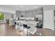 Open kitchen with gray cabinetry, a spacious island with barstool seating, and stainless steel appliances at 3546 Brampton Ln, Westfield, IN 46074